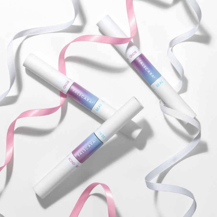 Falscara - Bond & Seal, drie witte tubes met een ombre kleurverloop, omringd door roze en witte linten.