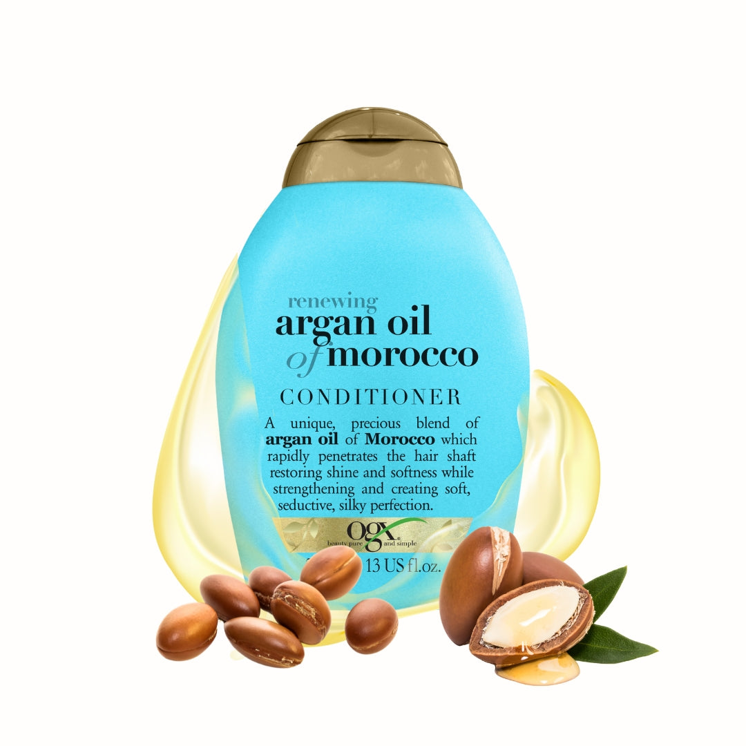 Renewing + Argan Oil Of Morocco Conditioner in een lichtblauwe fles met gouden dop, omringd door argannoten.