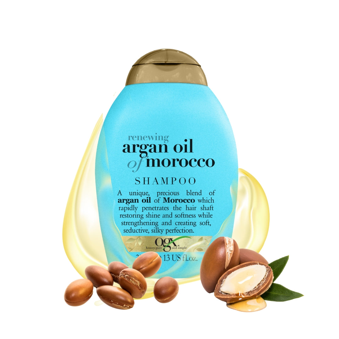 Renewing + Argan Oil Of Morocco Shampoo in een blauwe fles met gouden dop, omringd door argannoten en olie.