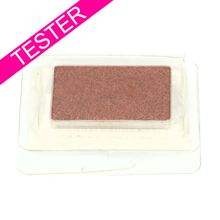 Eyeshadow Monos - Stubborn Tester, een rechthoekige, glanzende bronzen oogschaduw in doorzichtige verpakking.